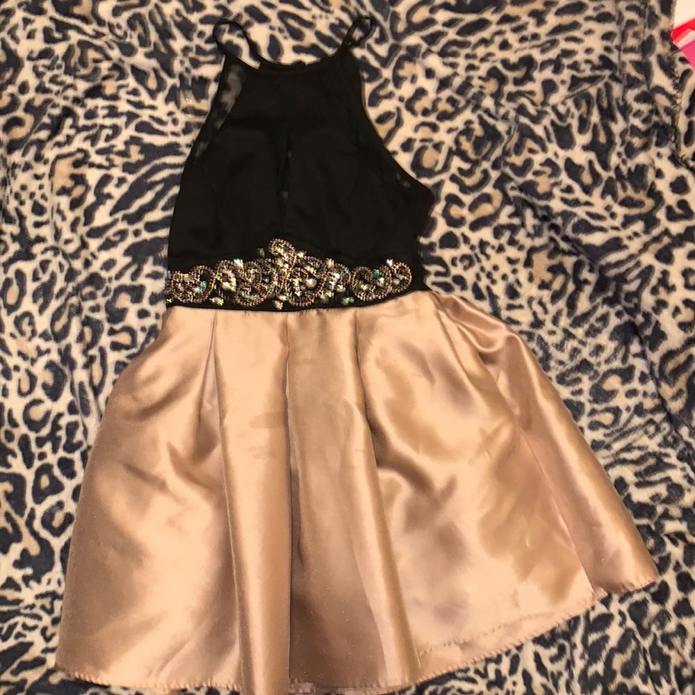 This is a Size 3 Dress. It’s gold & black with gold beading. Very beautiful